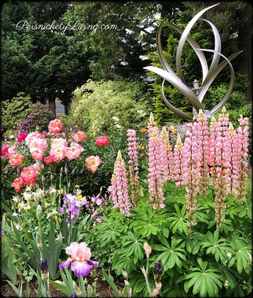 Flower bed with Garden Art and pretty blooms