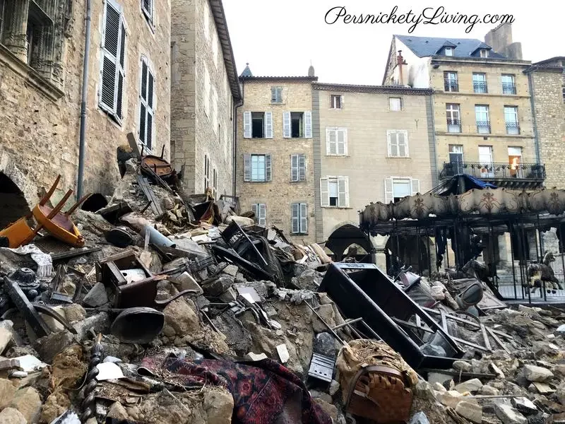 Fake stone rubble and furnishings in front of old buildings
