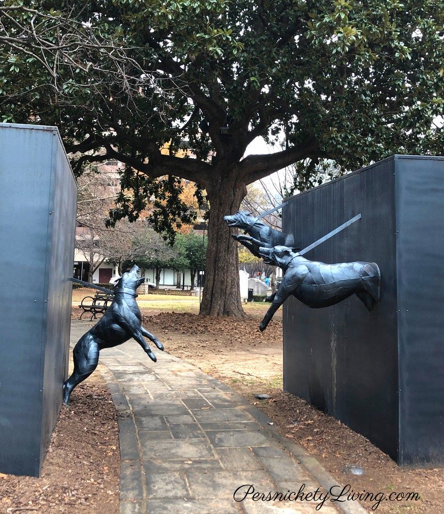 Path between vicious police dogs in a sculpure