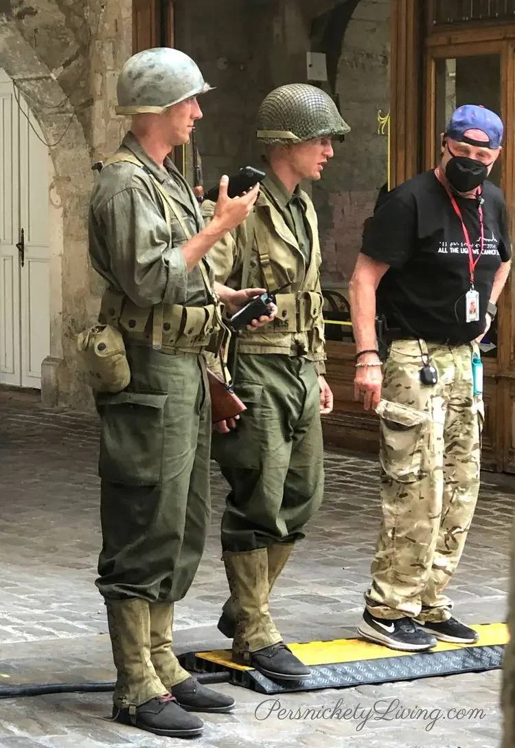 Two actors in soldier costumes and a crew member for all the light we cannot see