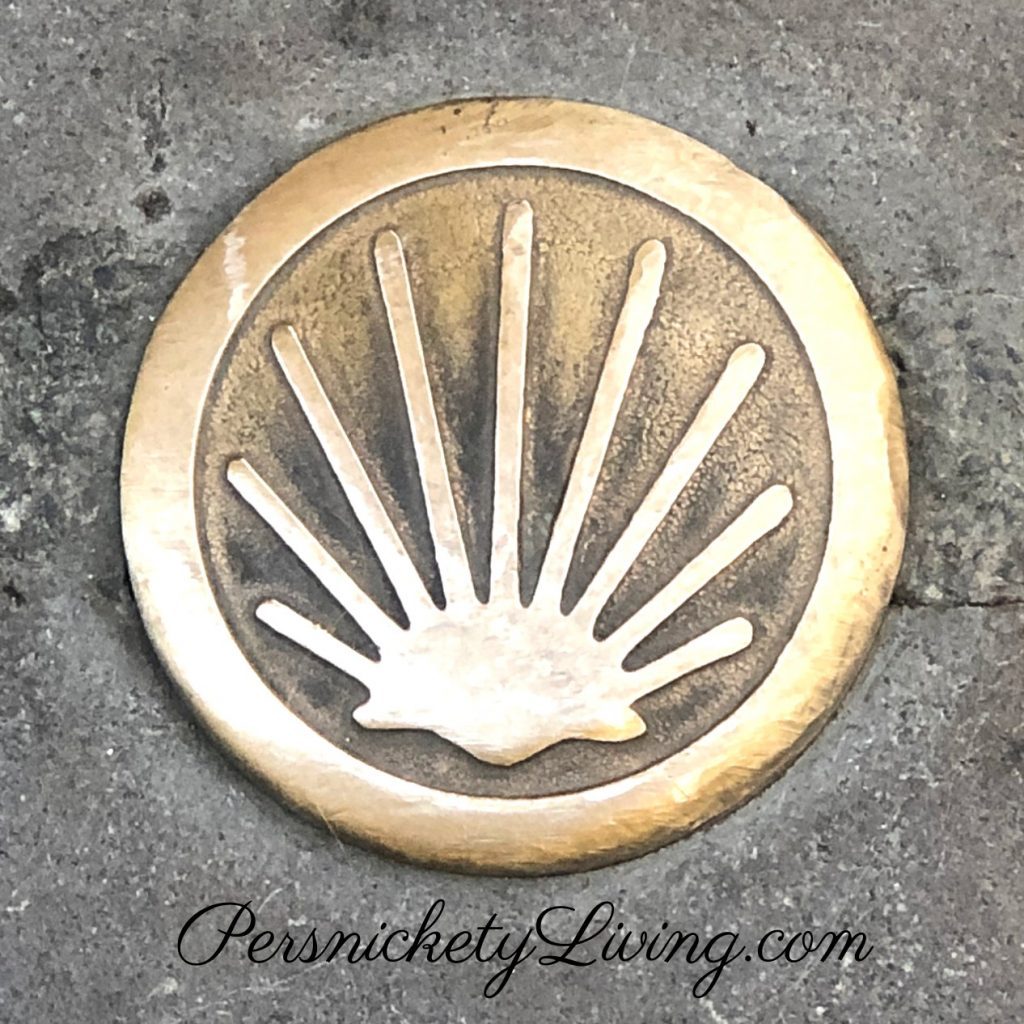 gold metal pilgrimage marker shell